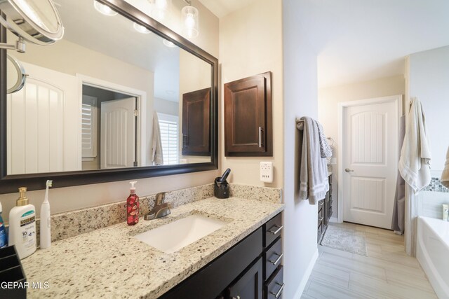 7825 Enchanted Ridge Dr, El Paso, TX 79911 - full bathroom featuring baseboards, vanity, and a tub