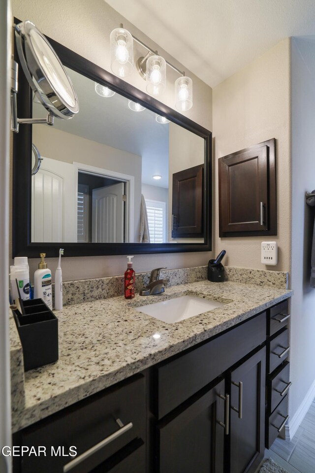 7825 Enchanted Ridge Dr, El Paso, TX 79911 - bathroom with baseboards and vanity