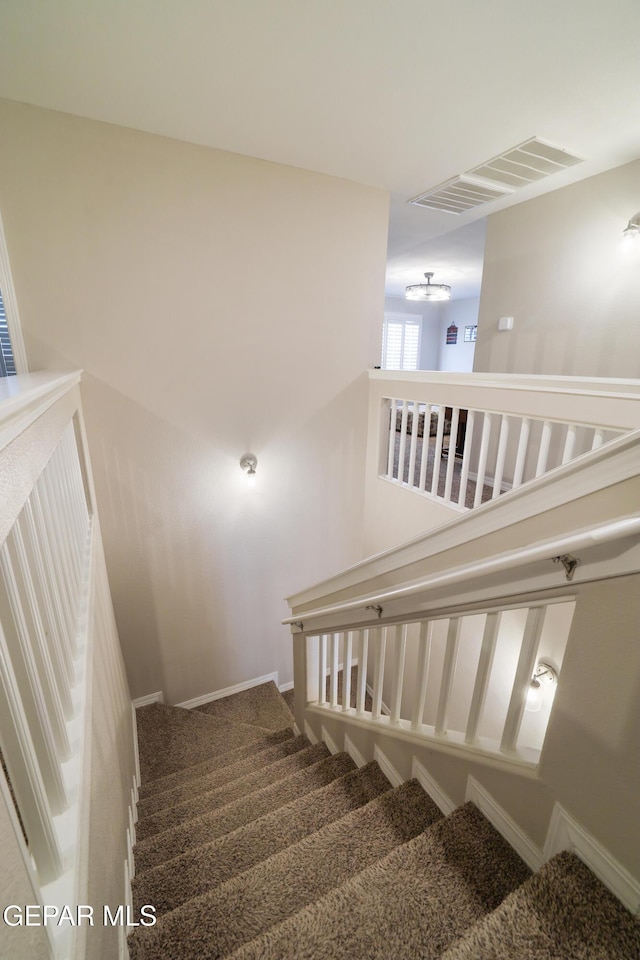 7825 Enchanted Ridge Dr, El Paso, TX 79911 - staircase with carpet, visible vents, and baseboards