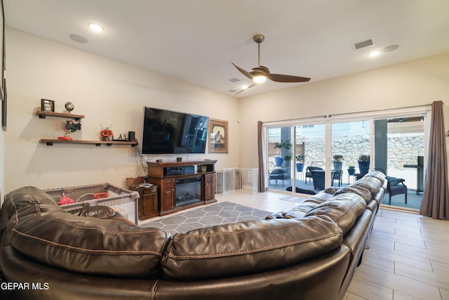 7825 Enchanted Ridge Dr, El Paso, TX 79911 - living area featuring a glass covered fireplace, visible vents, recessed lighting, lofted ceiling, and a ceiling fan