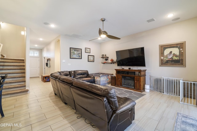 7825 Enchanted Ridge Dr, El Paso, TX 79911 - living room featuring recessed lighting, visible vents, a ceiling fan, a fireplace, and stairs