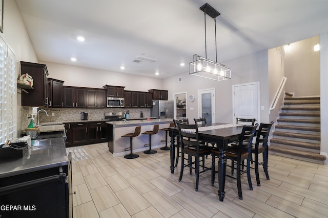 7825 Enchanted Ridge Dr, El Paso, TX 79911 - dining area with recessed lighting, wood tiled floor, stairway, and visible vents
