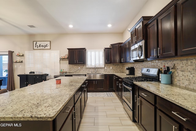 7825 Enchanted Ridge Dr, El Paso, TX 79911 - kitchen with stainless steel appliances, a sink, backsplash, and a wealth of natural light