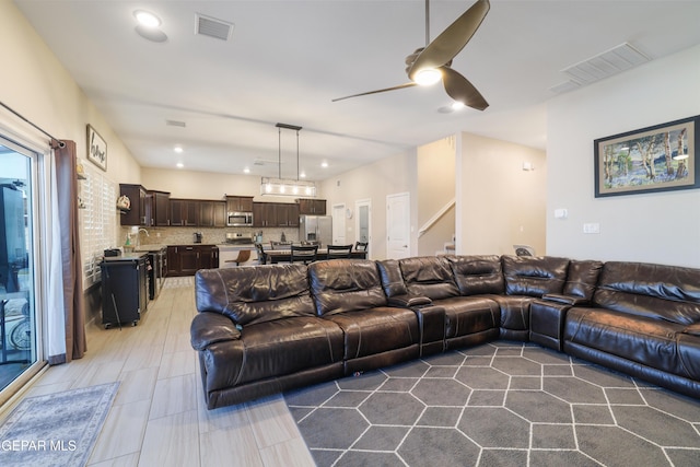 7825 Enchanted Ridge Dr, El Paso, TX 79911 - living area with a ceiling fan, visible vents, recessed lighting, and stairs