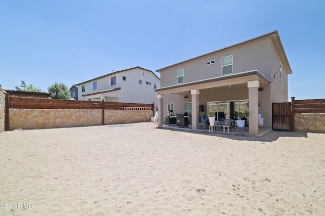 7825 Enchanted Ridge Dr, El Paso, TX 79911 - back of property with stucco siding, a fenced backyard, outdoor lounge area, and a patio