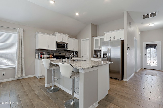 13877 Paseo Perlas Dr, El Paso, TX 79928 - kitchen featuring decorative backsplash, appliances with stainless steel finishes, visible vents, and light wood-style flooring
