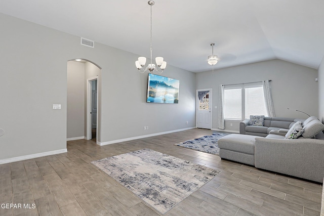 13877 Paseo Perlas Dr, El Paso, TX 79928 - living area with arched walkways, visible vents, ceiling fan with notable chandelier, lofted ceiling, and wood finished floors