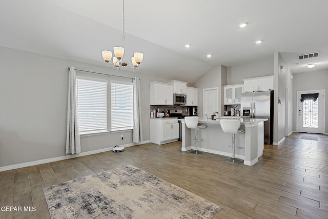 13877 Paseo Perlas Dr, El Paso, TX 79928 - kitchen featuring white cabinets, an inviting chandelier, backsplash, visible vents, and appliances with stainless steel finishes
