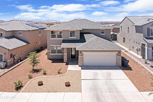 traditional home with a residential view, an attached garage, roof with shingles, concrete driveway, and stucco siding