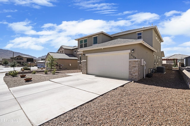 view of home's exterior featuring a garage, stucco siding, concrete driveway, and stone siding
