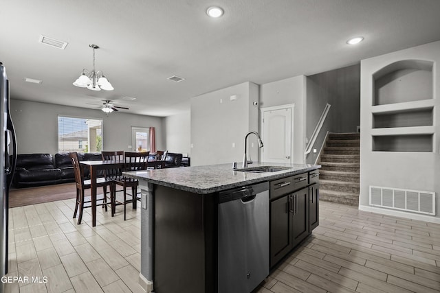 kitchen with stainless steel dishwasher, a sink, open floor plan, and visible vents