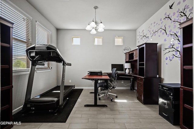 home office featuring baseboards, light wood-type flooring, and a notable chandelier