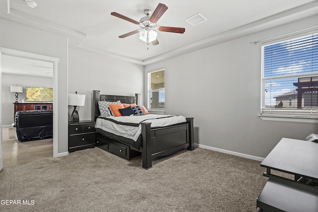 bedroom with visible vents, a ceiling fan, carpet flooring, and baseboards