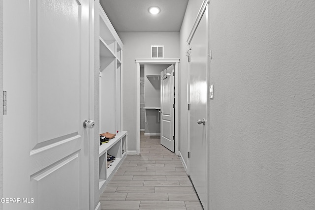 spacious closet featuring wood tiled floor and visible vents
