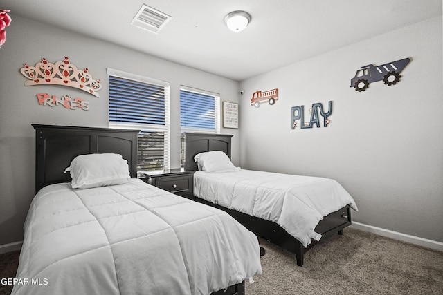 carpeted bedroom featuring baseboards and visible vents