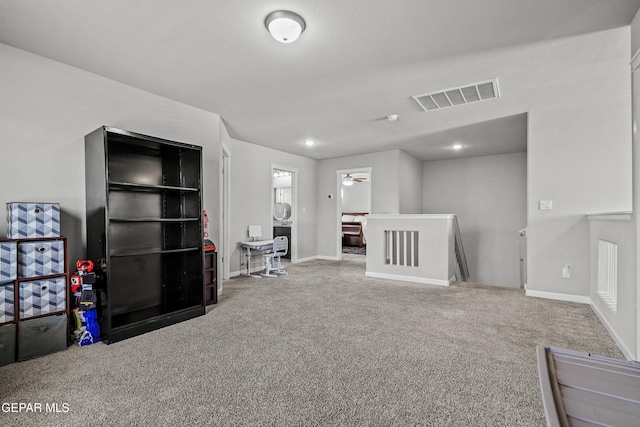 interior space with baseboards, visible vents, and carpet floors
