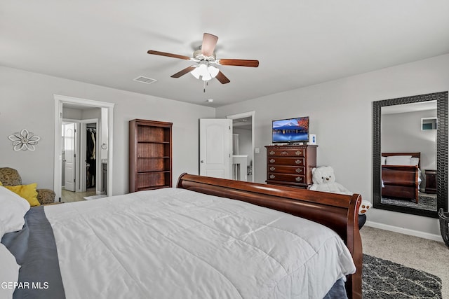 carpeted bedroom featuring a ceiling fan, visible vents, and baseboards