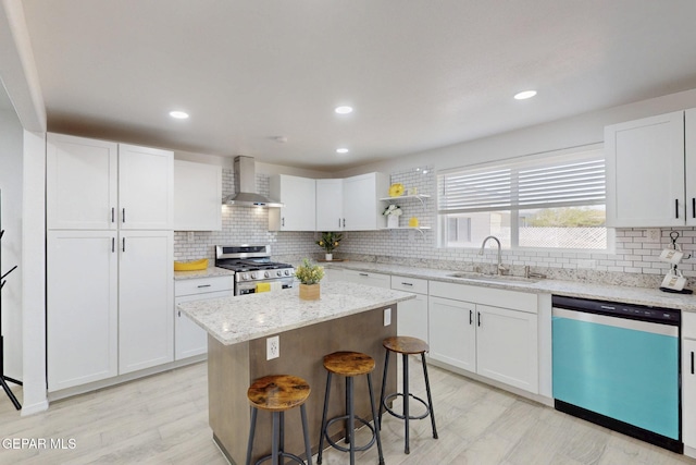 kitchen featuring wall chimney exhaust hood, a sink, decorative backsplash, gas stove, and dishwasher