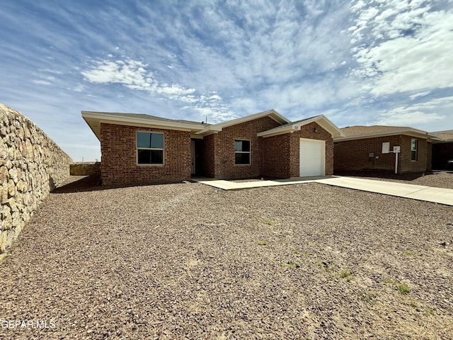 312 Via Cumbre Linda Cir, El Paso, TX 79928 - ranch-style house featuring an attached garage, driveway, and brick siding