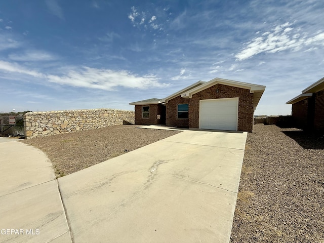312 Via Cumbre Linda Cir, El Paso, TX 79928 - ranch-style house featuring driveway, brick siding, and a garage