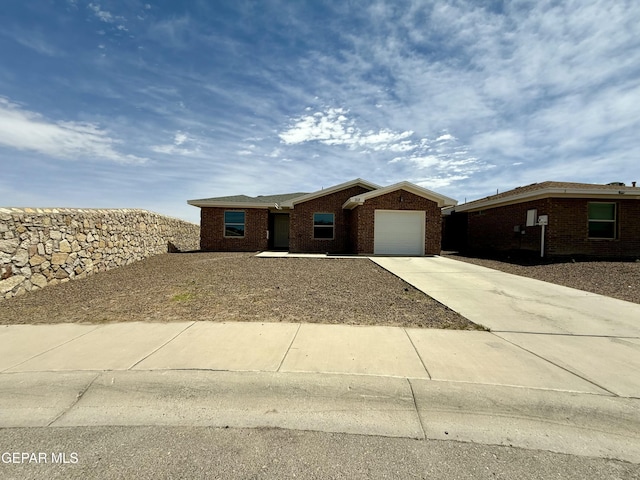 312 Via Cumbre Linda Cir, El Paso, TX 79928 - ranch-style home with concrete driveway, an attached garage, and brick siding