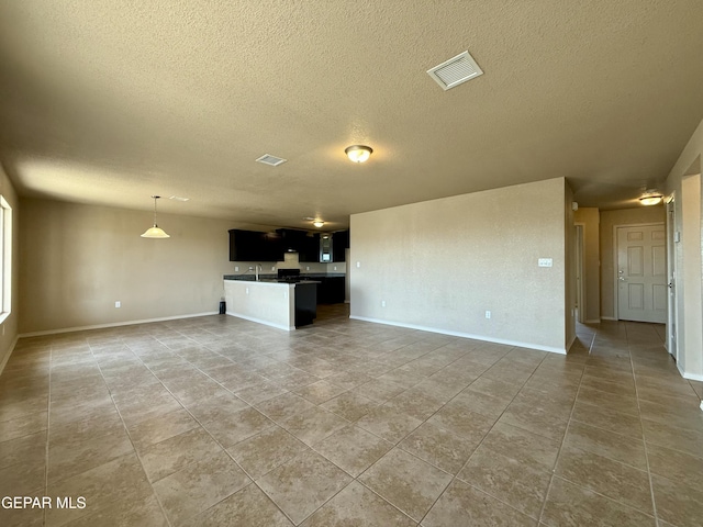 312 Via Cumbre Linda Cir, El Paso, TX 79928 - unfurnished living room with visible vents, a textured ceiling, and light tile patterned floors