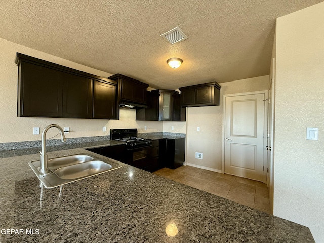 312 Via Cumbre Linda Cir, El Paso, TX 79928 - kitchen featuring under cabinet range hood, black range with gas stovetop, visible vents, light tile patterned floors, and a sink