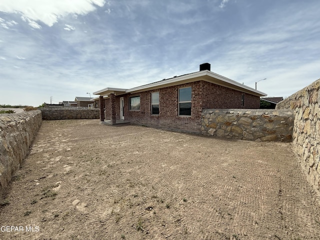 312 Via Cumbre Linda Cir, El Paso, TX 79928 - view of side of home with brick siding and a fenced backyard