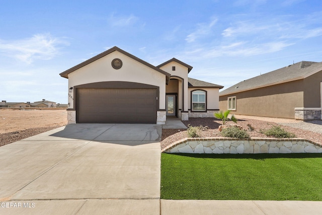 1205 Night Sky St, Horizon City, TX 79928 - mediterranean / spanish house featuring stucco siding, an attached garage, driveway, and a front lawn