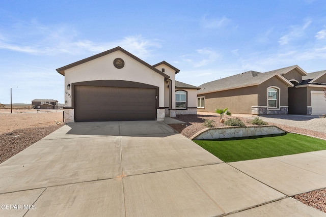 1205 Night Sky St, Horizon City, TX 79928 - view of front of house featuring stucco siding, stone siding, concrete driveway, and a garage