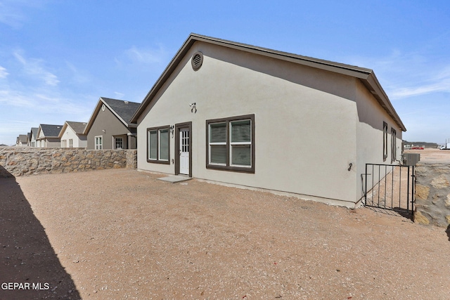 1205 Night Sky St, Horizon City, TX 79928 - rear view of property with stucco siding and fence