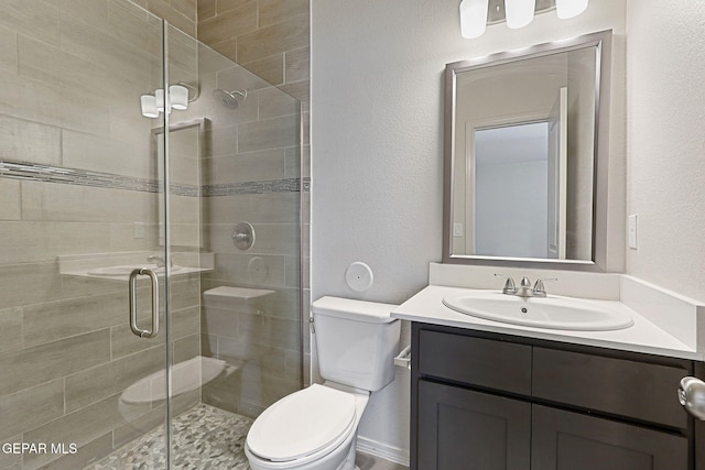 1205 Night Sky St, Horizon City, TX 79928 - bathroom with a stall shower, a textured wall, vanity, and toilet