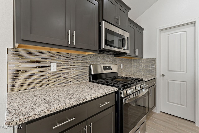 1205 Night Sky St, Horizon City, TX 79928 - kitchen featuring tasteful backsplash, light stone countertops, stainless steel appliances, and light wood-style floors