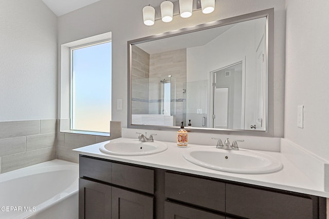 1205 Night Sky St, Horizon City, TX 79928 - bathroom featuring a bath, a sink, double vanity, and a stall shower