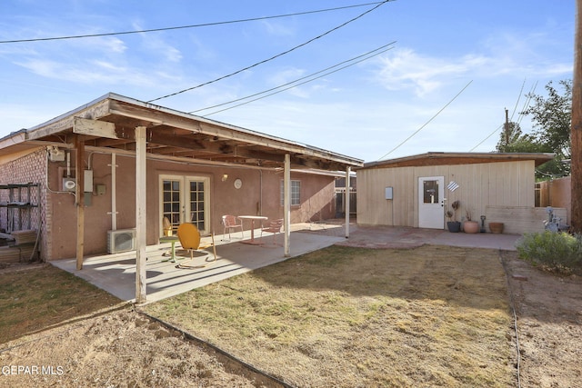 rear view of property with fence, a patio, and french doors