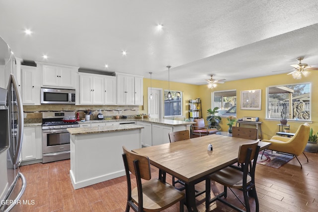dining space featuring recessed lighting, light wood-type flooring, and ceiling fan
