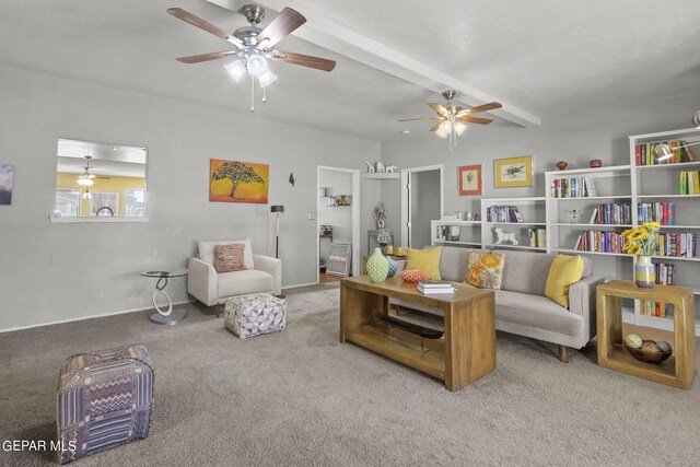 carpeted living area featuring beamed ceiling, a ceiling fan, and baseboards