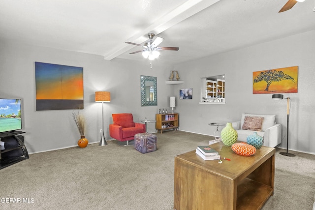 living room featuring baseboards, a ceiling fan, carpet flooring, and beam ceiling