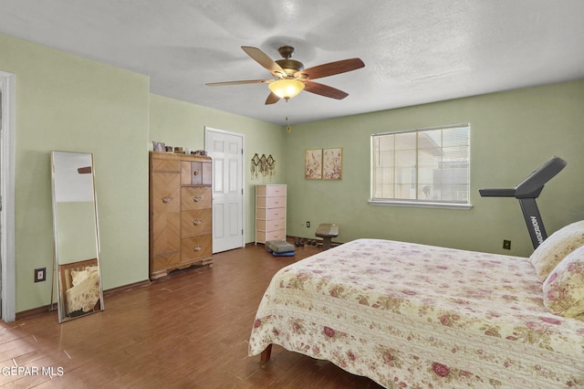 bedroom with ceiling fan, baseboards, and wood finished floors