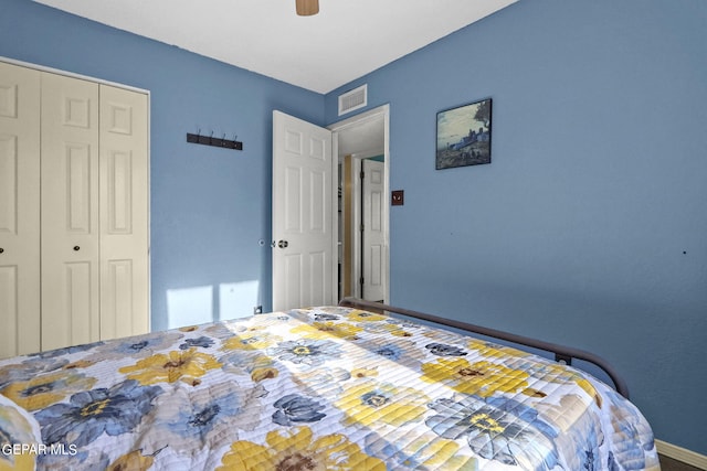 bedroom with a closet, baseboards, ceiling fan, and visible vents