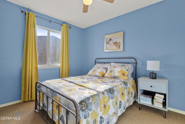 carpeted bedroom with ceiling fan and baseboards