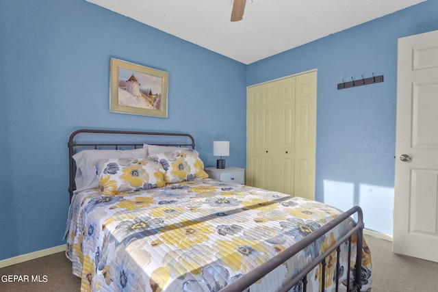 bedroom with ceiling fan, carpet floors, baseboards, and a closet