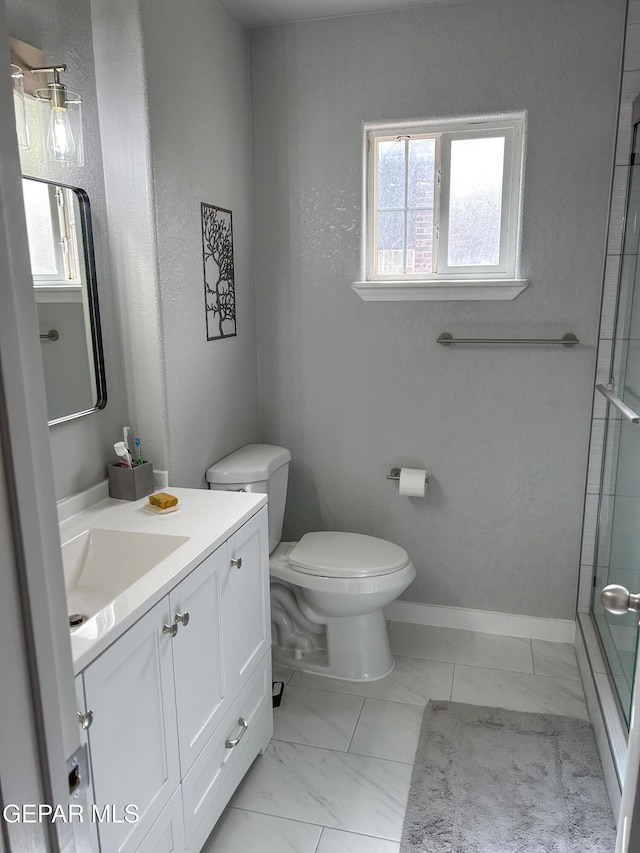 full bathroom featuring vanity, toilet, a healthy amount of sunlight, and a shower with door