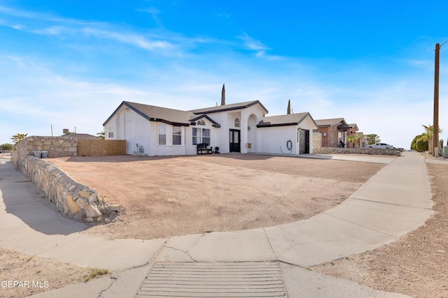 single story home featuring fence and a garage
