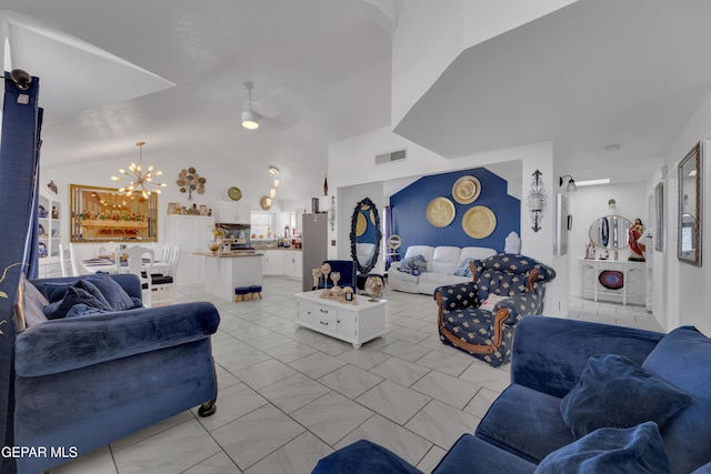 living area featuring ceiling fan with notable chandelier, vaulted ceiling, and visible vents