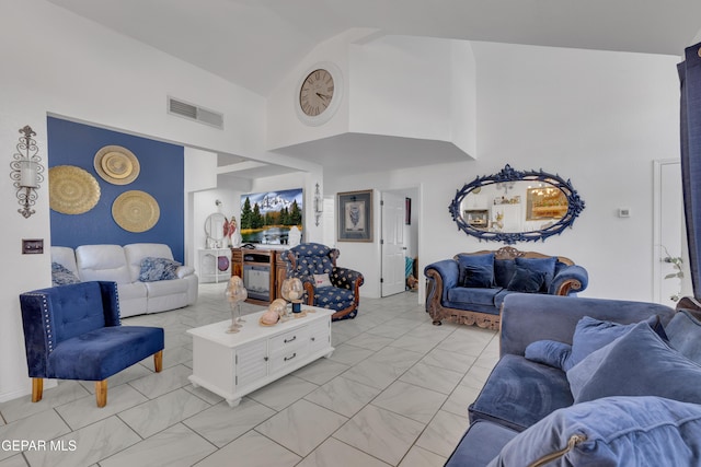 living room featuring visible vents, marble finish floor, and high vaulted ceiling