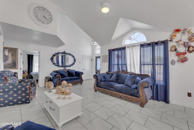 living room featuring high vaulted ceiling