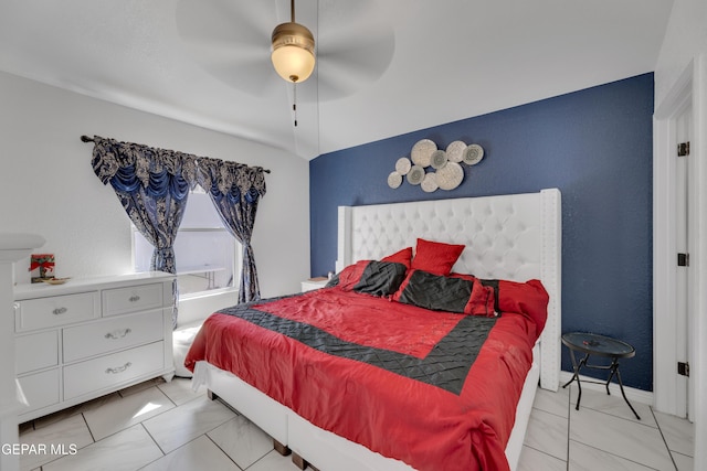 bedroom featuring marble finish floor and a ceiling fan