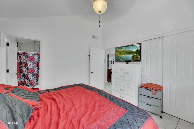 bedroom with a ceiling fan, a closet, marble finish floor, a high ceiling, and visible vents