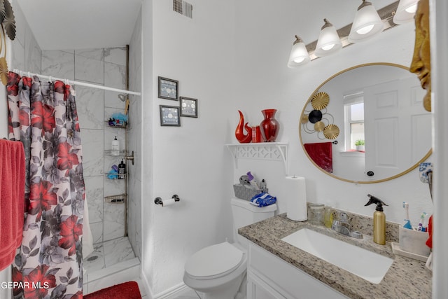 full bath with visible vents, vanity, tiled shower, and toilet
